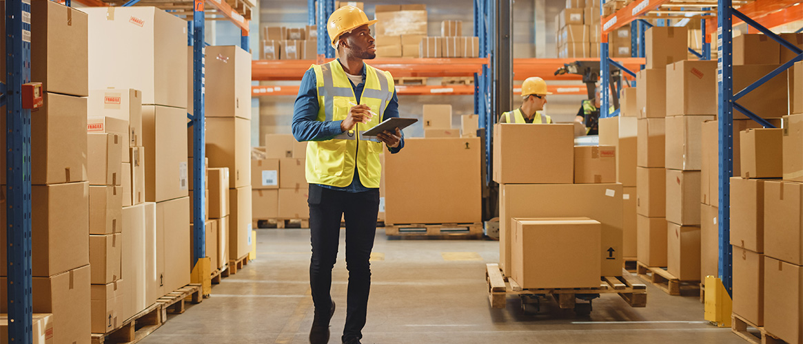 A warehouse worker takes an inventory of stock.