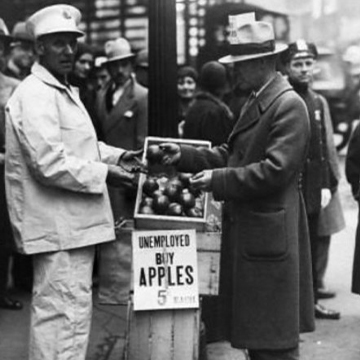 Unemployed man selling apples on the street, circa 1930. Unemployed man selling apples on the street, circa 1930.