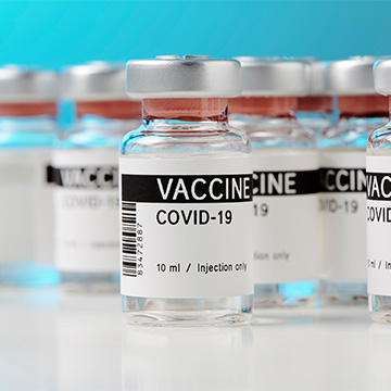 A group of COVID-19 vaccine vials. A group of COVID-19 vaccine vials.